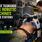 Ambulance Tasmania paramedic using a LUCAS mechanical CPR machine inside an ambulance during emergency patient care.
